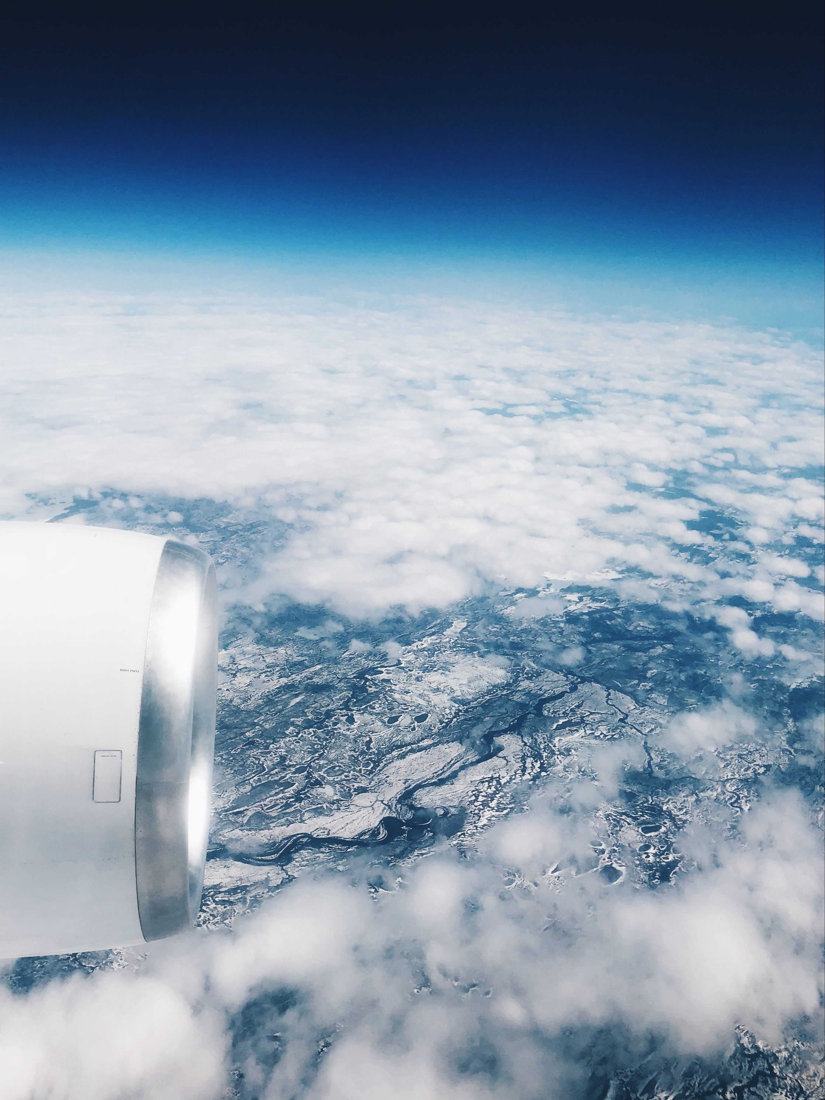 Airplane engine view from above the clouds